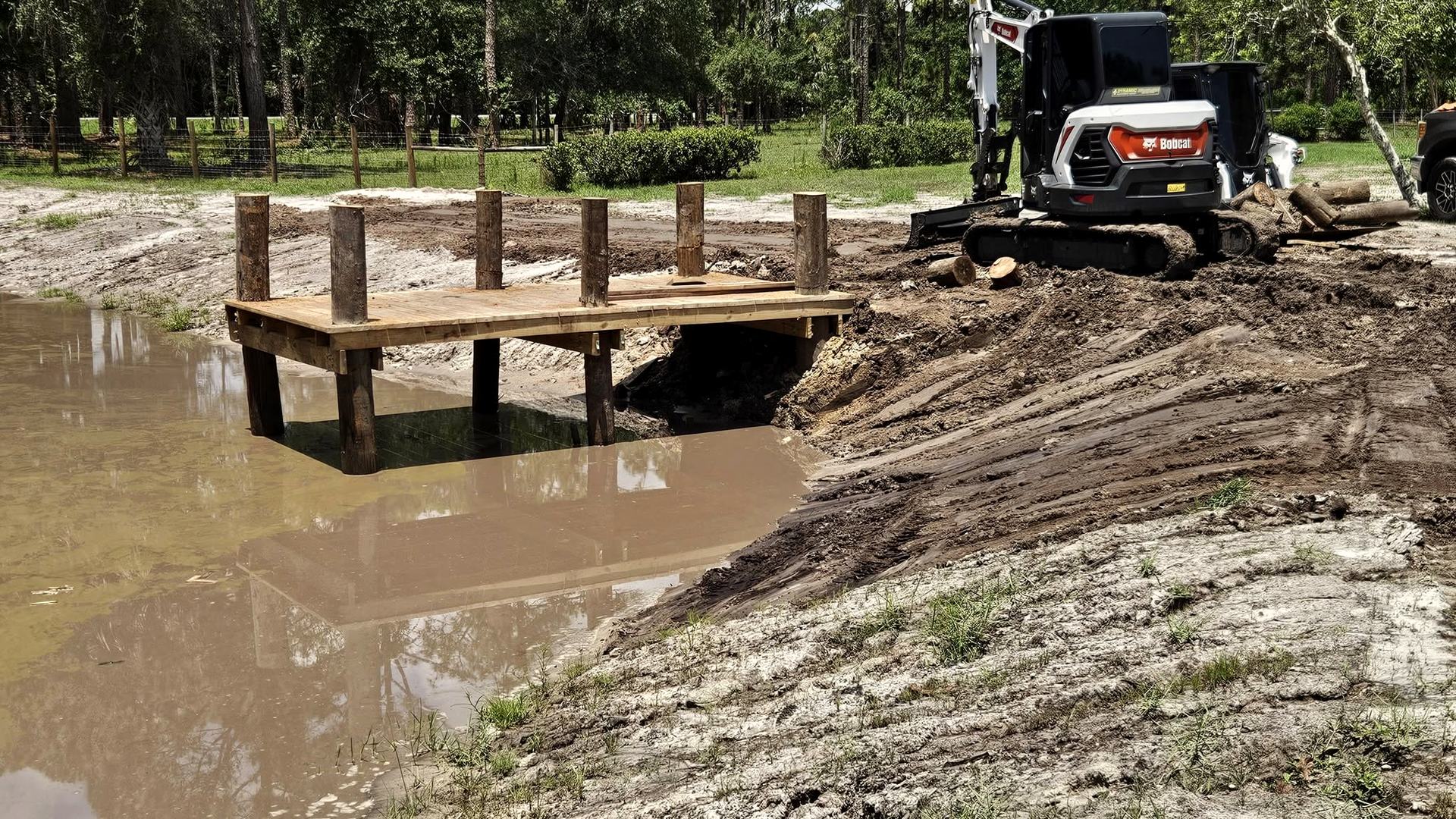 A new culvert crossing with a timber bridge and the compact excavator alongside