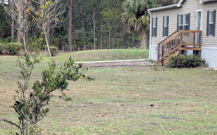 A regraded yard with a new swale and downspout drain line running out to daylight